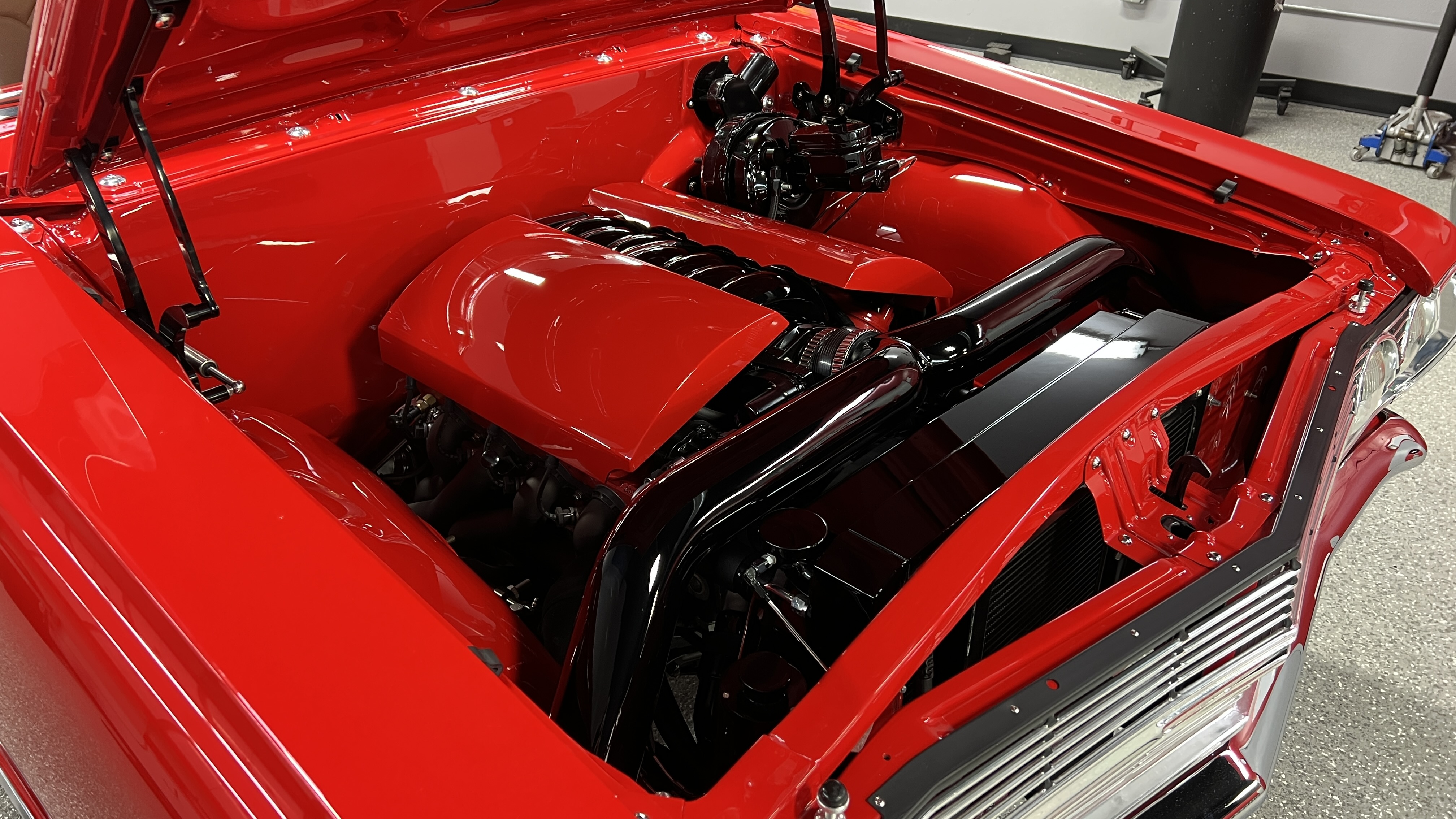 Polished and detailed engine bay on a classic show car at The Recon Pros Huntington Beach
