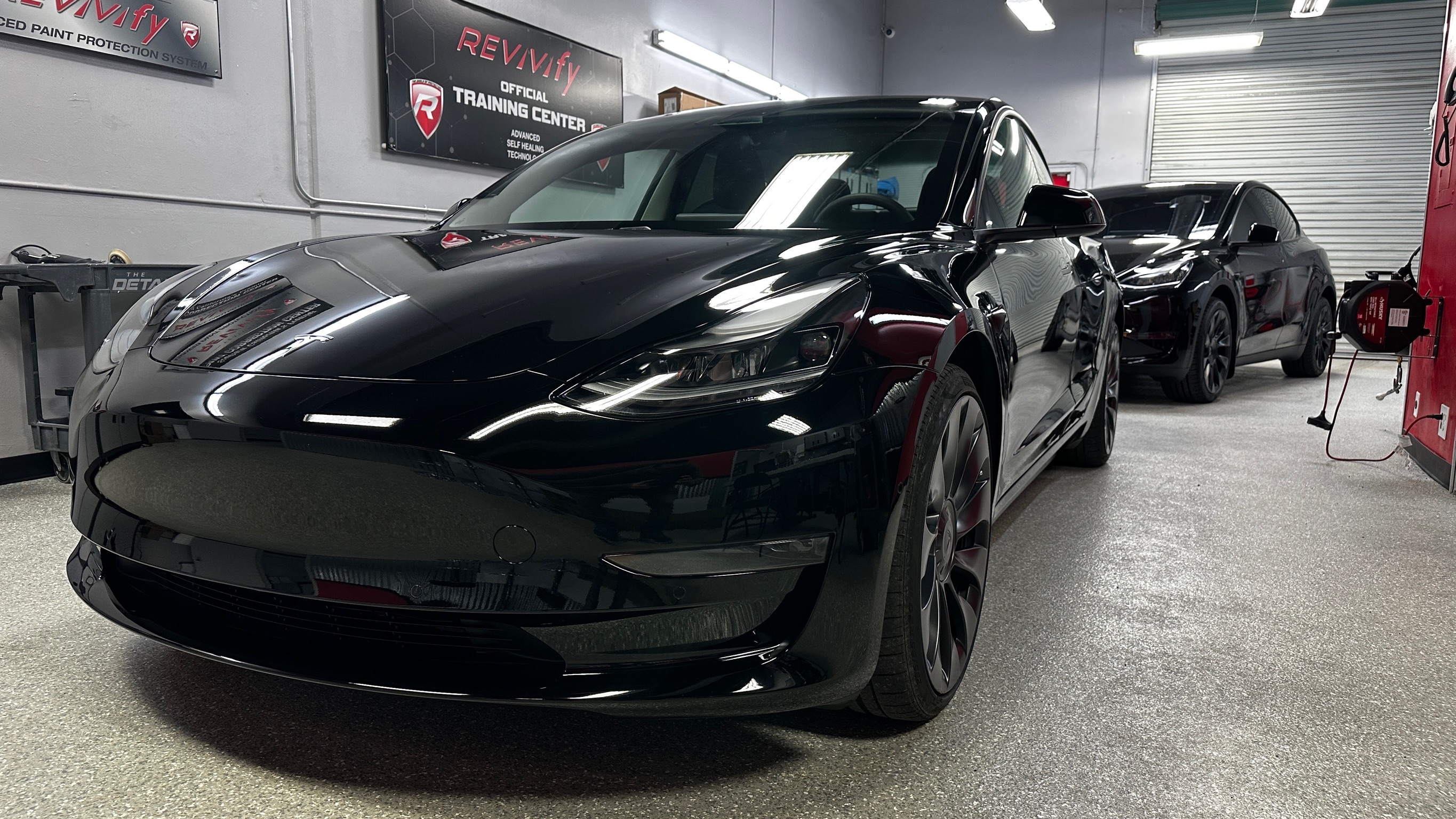Black Tesla after paint correction and Revivify self-healing coating install
